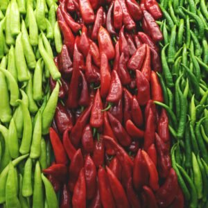 A colorful arrangement of fresh green and red chili peppers showcasing natural freshness and spice.
